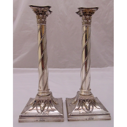 402 - A pair of Victorian hallmarked silver table candlesticks, of corinthian column form with husk spiral... 