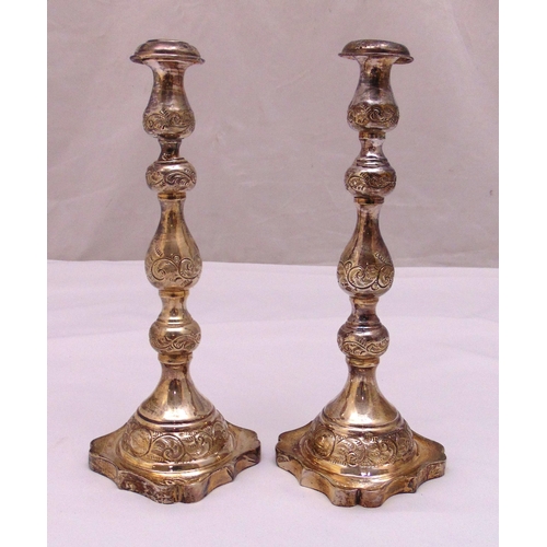 403 - A pair of hallmarked silver table candlesticks, tubular knopped form engraved with flowers and scrol... 