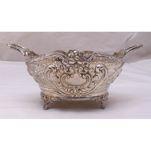 406 - A Victorian hallmarked silver bread basket, oval pierced sides with scroll and leaf chased panels, t... 