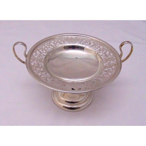 407 - A hallmarked silver cake stand circular scroll pierced with looped side handles on raised circular b... 