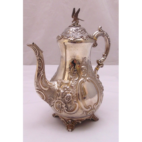 409 - A Victorian hallmarked silver coffee pot, pear shaped profusely chased with flowers, scrolls and lea... 