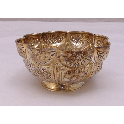 412 - A late Victorian hallmarked silver shaped circular bowl, lobbed sides chased with flowers and leaves... 