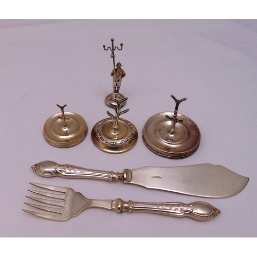 474 - Four hallmarked silver ring stands and a pair of fish servers with silver handles