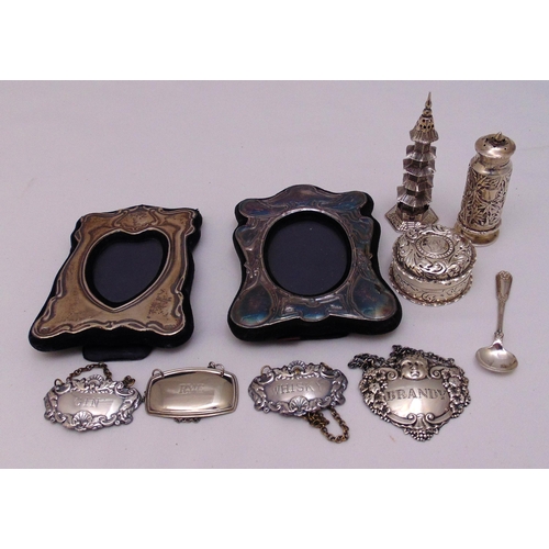 475 - Two hallmarked silver photograph frames, a hallmarked silver circular pill box, a Chinese silver mod... 