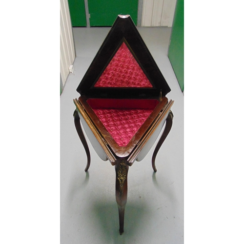 13 - A 19th century triangular drop flap table, the hinged cover opens to reveal a mirror and material li... 