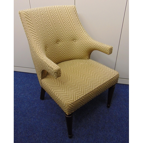 38 - A mid 20th century upholstered armchair on four tapering cylindrical legs