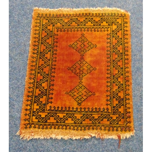 51 - A Persian wool Prayer rug with orange ground and repeating geometric pattern, 72 x 56cm