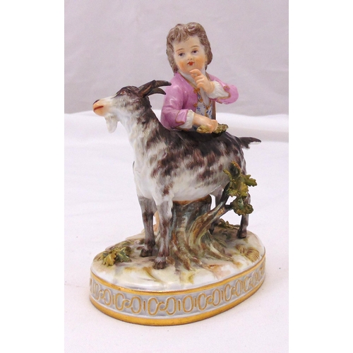 173 - A Meissen figurine of a boy with a goat on oval raised naturalistic base, marks to the base, 14.5cm ... 