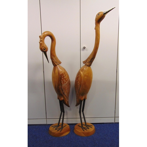 231 - A pair of large hand carved cranes on raised circular plinths, 144.5 x 20 x 60cm