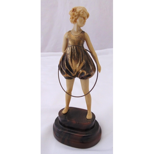 240 - An Art Deco figurine of a girl with a hula hoop mounted on an oval stepped base, 23cm (h)