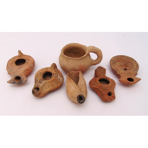 263 - A quantity of archaeological finds to include five Roman terracotta oil lamps of various form and si... 