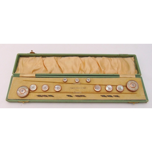 268 - A cased set of French Mother of Pearl buttons and hair pins