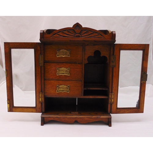 269 - An Edwardian rectangular oak cased smokers cabinet, three drawers with brass handles and two hinged ... 