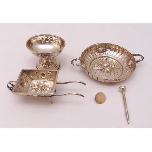 389 - A quantity of white metal to include a bonbon dish in the form of a wheel barrow, a two handle nut d... 