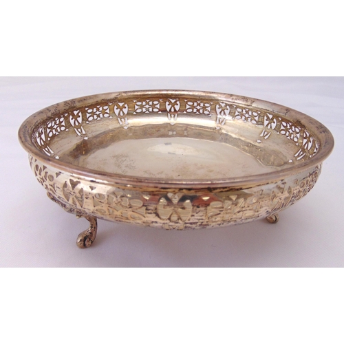 395 - A Mappin and Webb hallmarked silver bowl of circular form with scroll pierced sides on three leaf ca... 