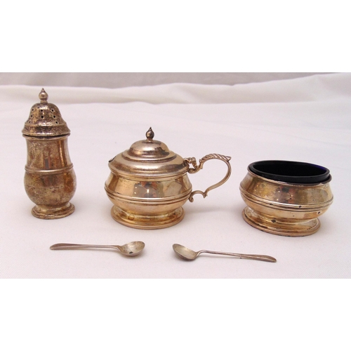 402 - A Mappin and Webb hallmarked silver three piece condiment set, banded to the sides, to include two c... 