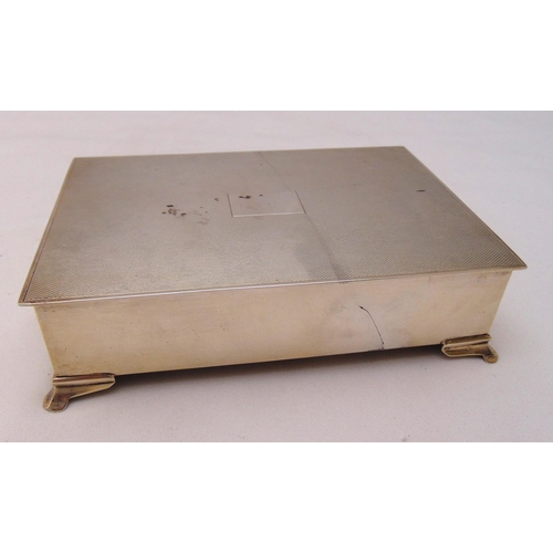 418 - A hallmarked silver rectangular cigarette box engine turned cover, cedar wood lining on four bracket... 