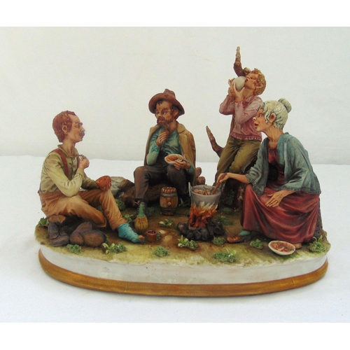 114 - A Capodimonte figural group of Italian peasants eating and drinking on raised oval base 29 x 39 x 30... 