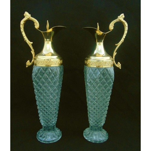 133 - A pair of cut glass and gilt metal ewers with double scroll handles on raised circular bases, 39.5cm... 