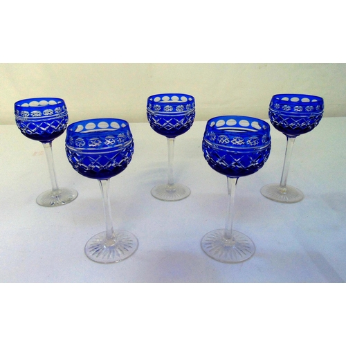 141 - A set of five blue cut glass hock glasses on raised cut glass circular bases