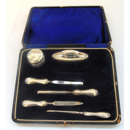 375 - A cased hallmarked silver manicure set to include nail buffer, nail file and a glass dressing table ... 