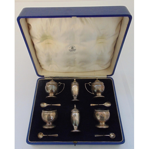 376 - A Mappin and Webb cased hallmarked silver double condiment set to include salts, pepperettes, mustar... 