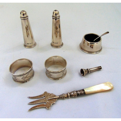 396 - A quantity of hallmarked silver to include condiments, napkin rings, a cigar piercer and a pickle fo... 