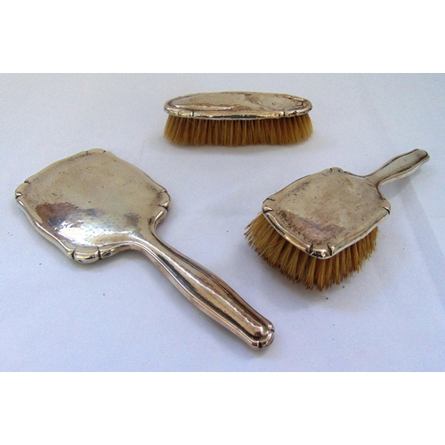 400 - White metal dressing table set to include a hand mirror, a hair brush and a clothes brush