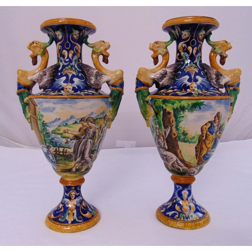 102 - A pair of Italian Fainence vases on circular bases the sides decorated with classical figures in a l... 