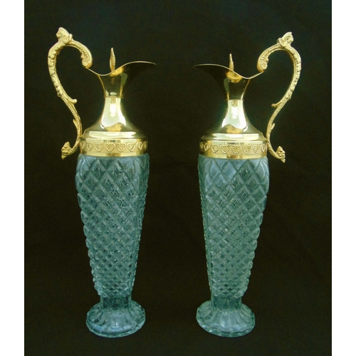 120 - A pair of cut glass and gilt metal ewers with double scroll handles on raised circular bases, 39.5cm... 