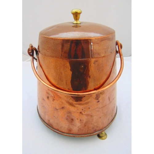 156 - A copper canister with pull off cover and swing handle on three pad feet, 43cm (h)