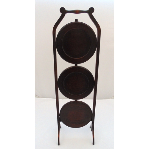 19 - A mahogany three tier plate stand of customary form, 89 x 27.5cm