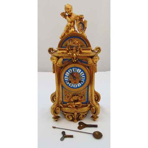 268 - A French gilded metal mantle clock with painted panels, the porcelain dial with Roman numerals surmo... 