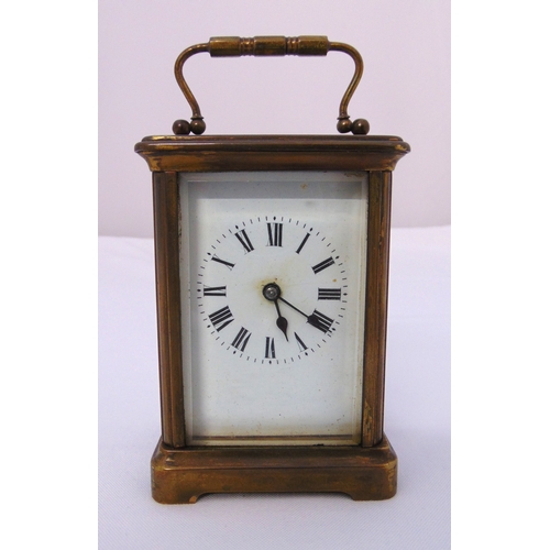 275 - A brass cased carriage clock of customary form with white enamel dial and Roman numerals, 12cm (h)