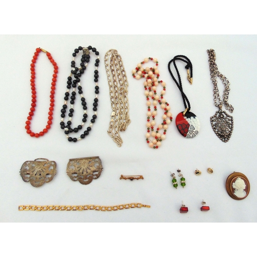 306 - A quantity of silver and costume jewellery to include necklaces, a cameo brooch and a belt buckle