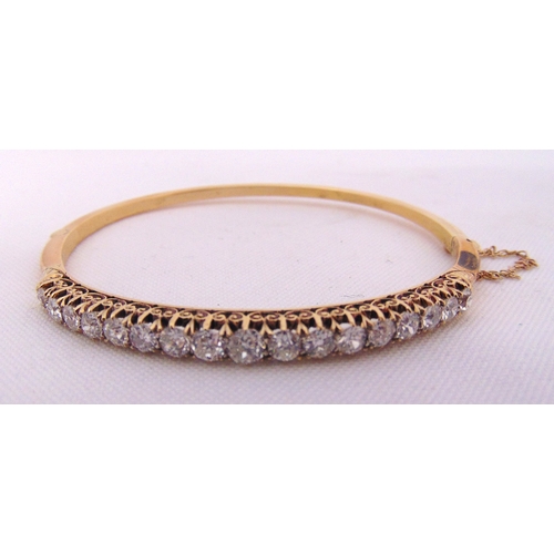 312 - Victorian gold bangle set with seventeen old cut diamonds, gold tested 15ct, to include original lea... 