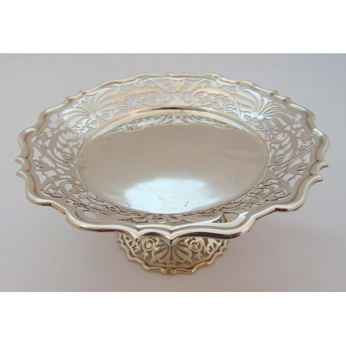 358 - A hallmarked silver cake stand, circular with scroll pierced sides on raised circular scroll pierced... 