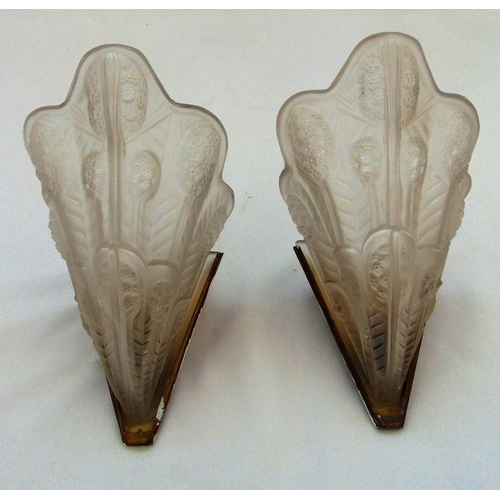 36 - A pair of Art Deco frosted glass wall lights of shaped oval form with metal mounts