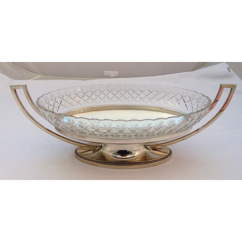 364 - A continental white metal oval table centrepiece with pierced side handles on raised oval base with ... 