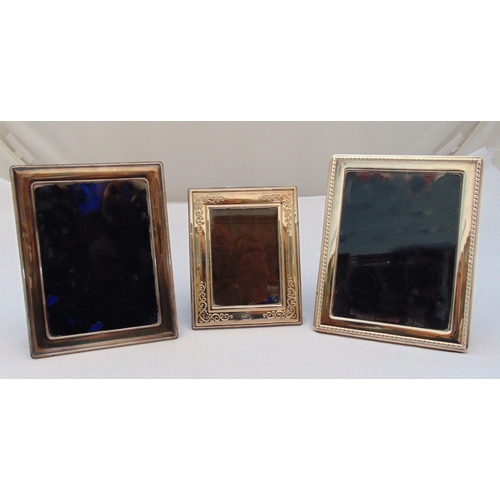 380 - Three hallmarked silver rectangular photograph frames with various borders