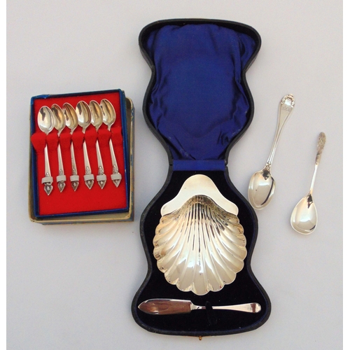 383 - A quantity of hallmarked silver to include a shell shape butter dish and knife in fitted case, a cas... 