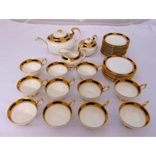 104 - Aynsley blue and gold part tea service to include cups, saucers, a teapot, milk jug and sugar bowl (... 