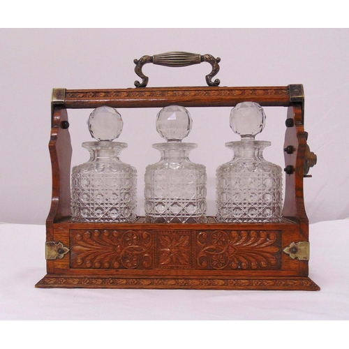 167 - An early 20th century three bottle Tantalus, to include three cut glass decanters with drop stoppers