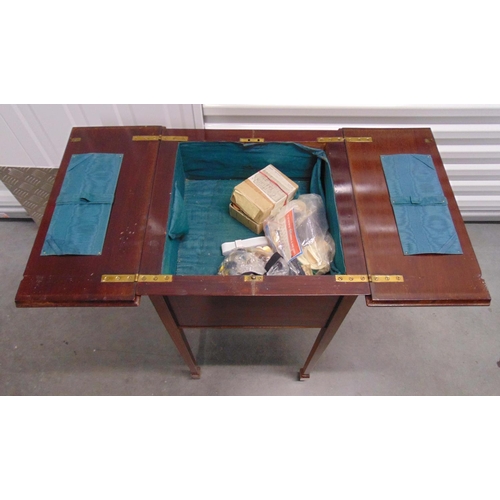 17 - An Edwardian rectangular sewing table with hinged top to reveal fitted interior on four tapering rec... 