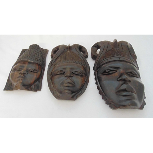 219 - Three African carved wood masks, two with rams horns, the largest 36cm (h)