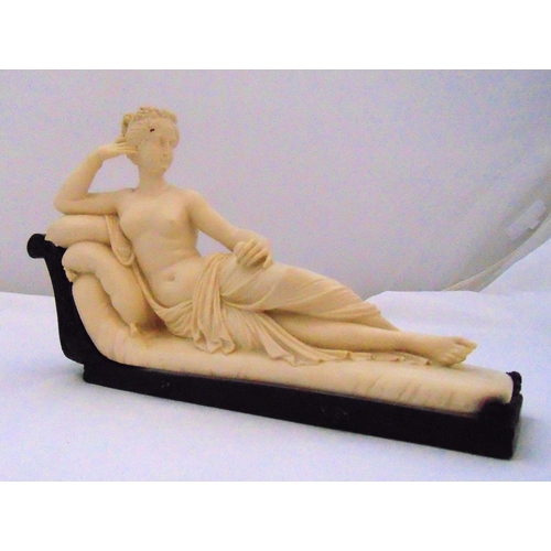 223 - Venus Victrix composition figurine reclining on her chaise longue mounted on a resin base, 21.5 x 36... 