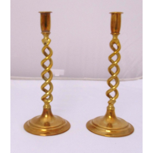 225 - A pair of brass pierced and twisted stem table candlesticks on raised circular bases, 31cm (h)