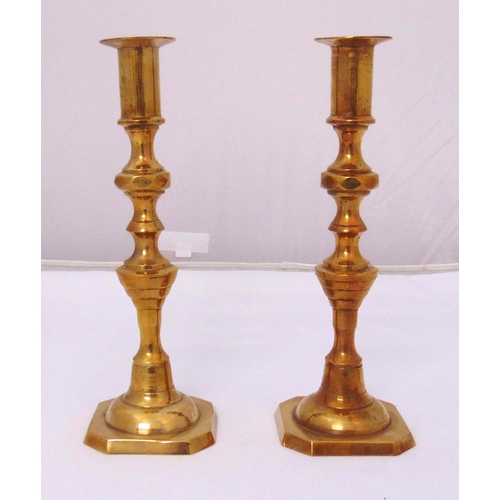 226 - A pair of early 20th century brass knopped stem table candlesticks on raised square bases, 27cm (h)