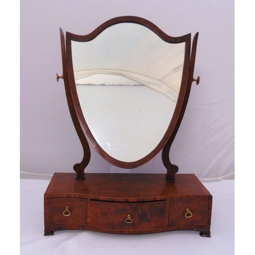 38 - An Edwardian mahogany dressing table mirror of shield form on shaped rectangular base and three draw... 