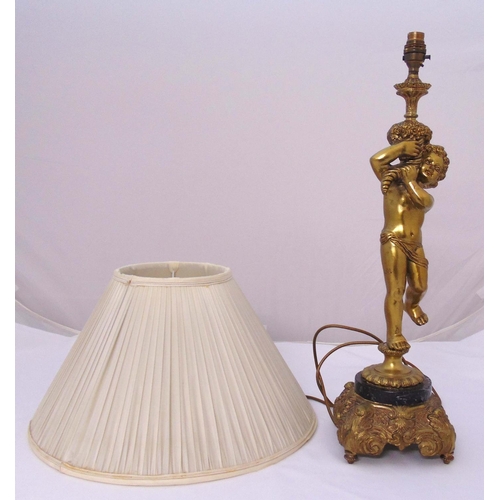 47 - A gilt metal figural table lamp on raised base to include shade, 62cm (h)